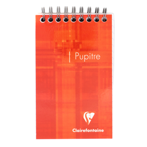 A spiral-bound notebook with a bright orange-red cover featuring the white text 'Pupitre' and the Clairefontaine logo, shown on a plain white background.