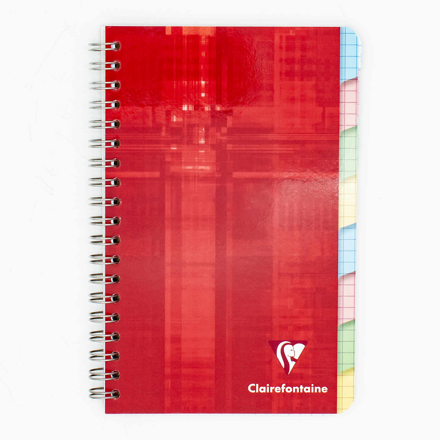 A spiral-bound notebook with a red cover featuring 8 index tabs that are graph lined and the Clairefontaine logo near the bottom. The right edge shows colorful page dividers in pastel shades of pink, yellow, green, and blue.