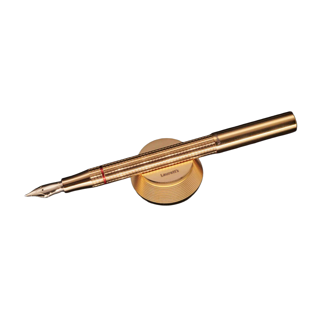 A gold-finished fountain pen with a matching circular gold stand, photographed on a clean white background.