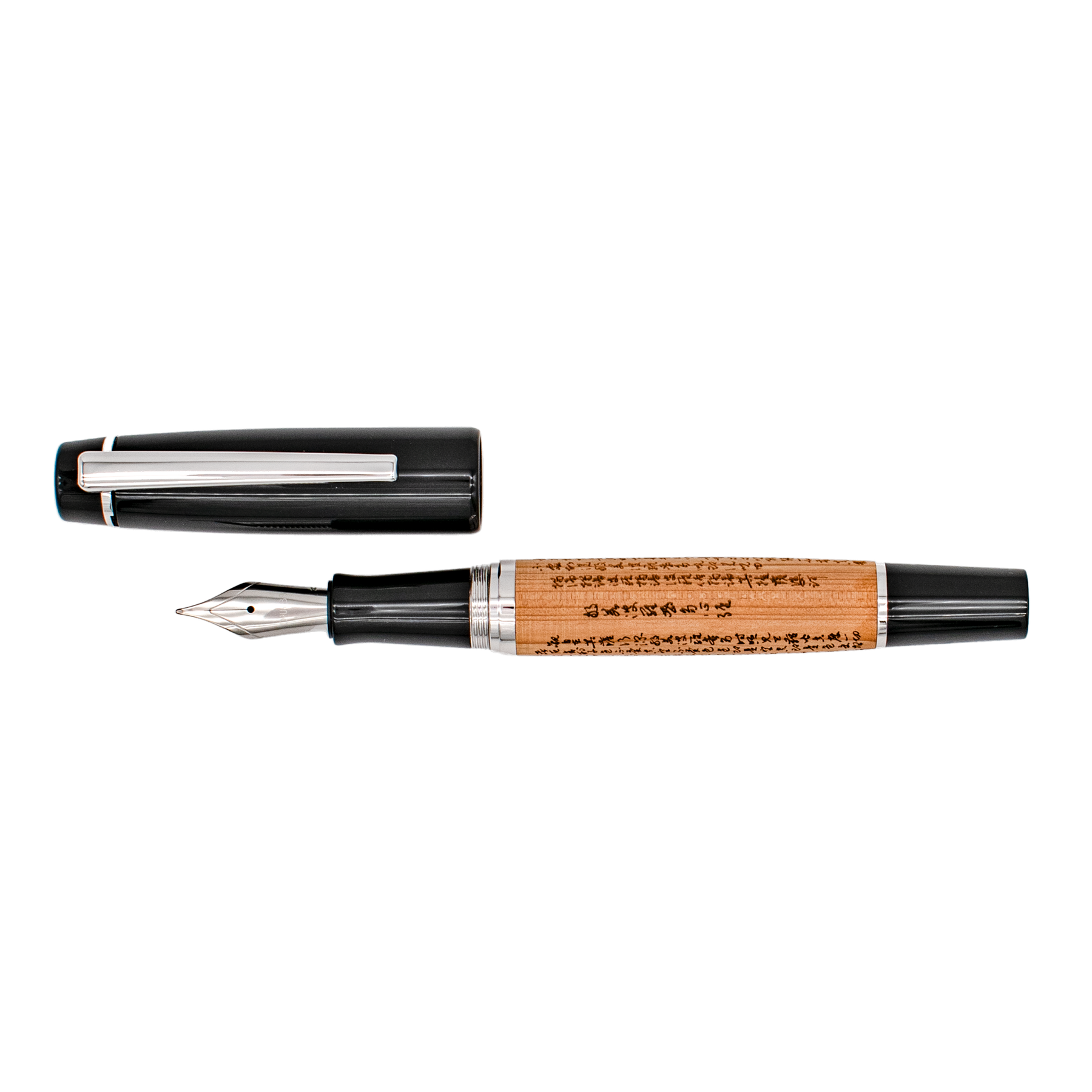 A wood barrel fountain pen with the Sanskrit 'Heart Sutra' engraved in it with black and silver trim details, shown with its cap removed and placed above it on a plain white background.