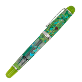 A clear frosted fountain pen with translucent lime green details and silver trim with details of turquoise and green leaves and butterflies, and a red ladybug on the cap, diagonally on a white background.