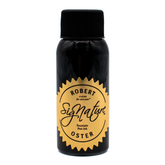 A bottle of Robert Oster Signature Fountain Pen Ink, featuring a black bottle and cap with a gold circular label.
