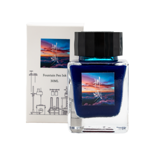 A bottle of blue fountain pen ink with the box packaging on a plain white background.