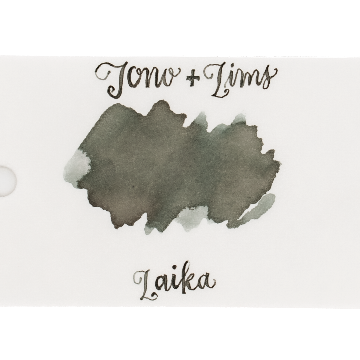 An ink swatch in a gray-green on white paper, with the text 'Tono+Lims' at the top and 'Laika' at the bottom in matching script on a plain white background.