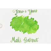 An ink swatch in lime green on white paper, with the text 'Tono+Lims' at the top and 'Mali Garnet' at the bottom in matching green script on a plain white background.
