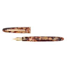 Tortoise shell and gold trim fountain pen with the cap placed above its barrel on a plain white background.